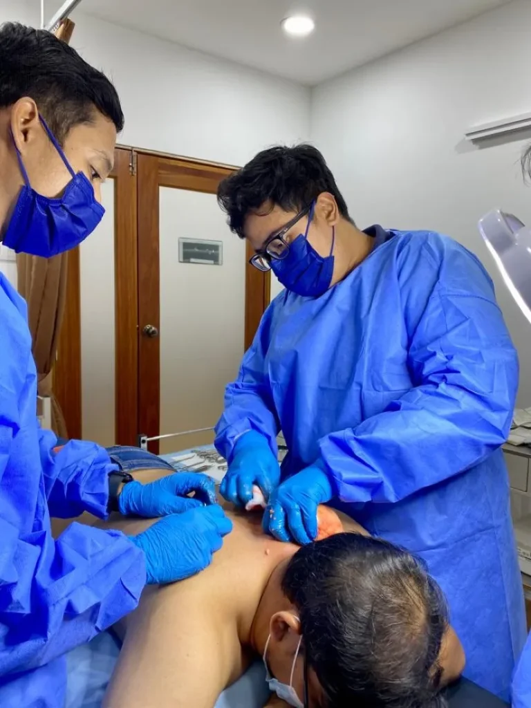 Doctors performing a minor surgical procedure at the clinic